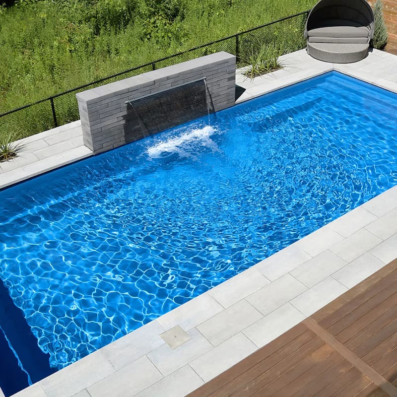 Fiberglass pool with waterfall feature and lounge area