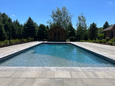 Stamped concrete patio with stone-like patterns around pool