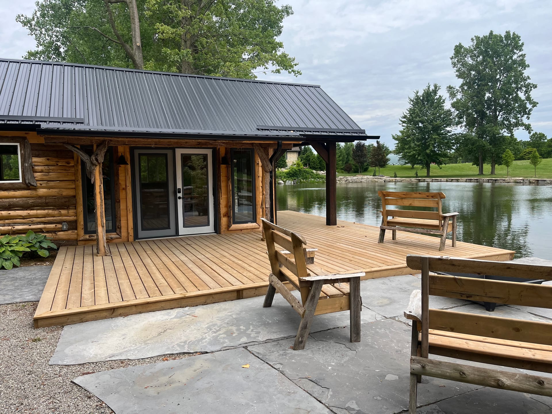 Custom log cabin with deck overlooking the water