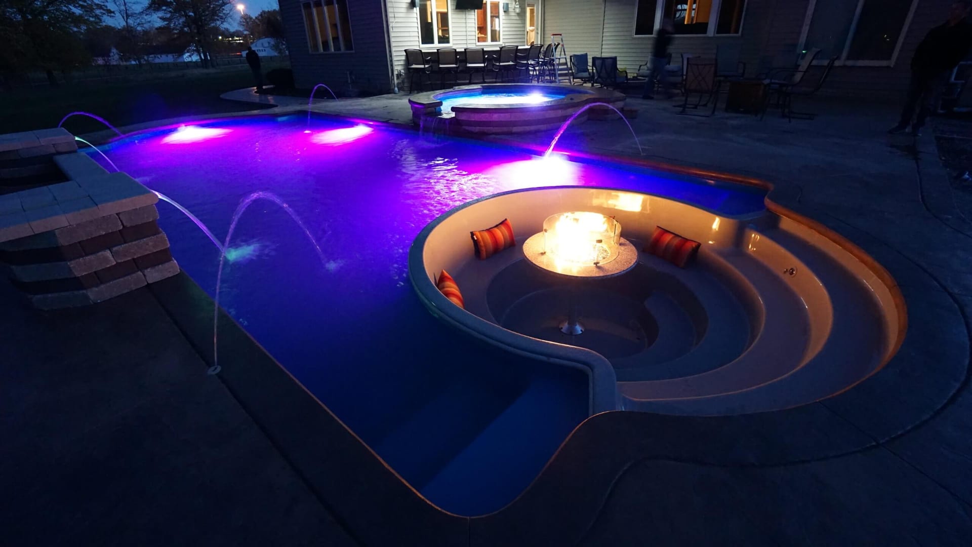 Thursday Pools Cortona fiberglass pool with fire pit and water features